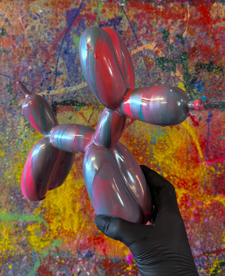 Balloon dog sculpture with glossy pink, turquoise and grey acrylic swirls